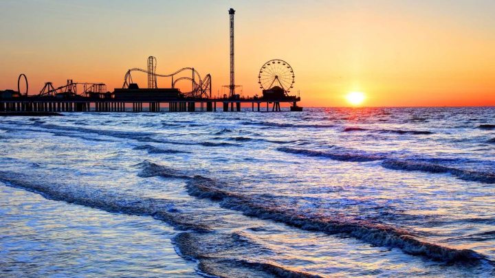 Pleasure Pier over the ocean with the sun setting in the background