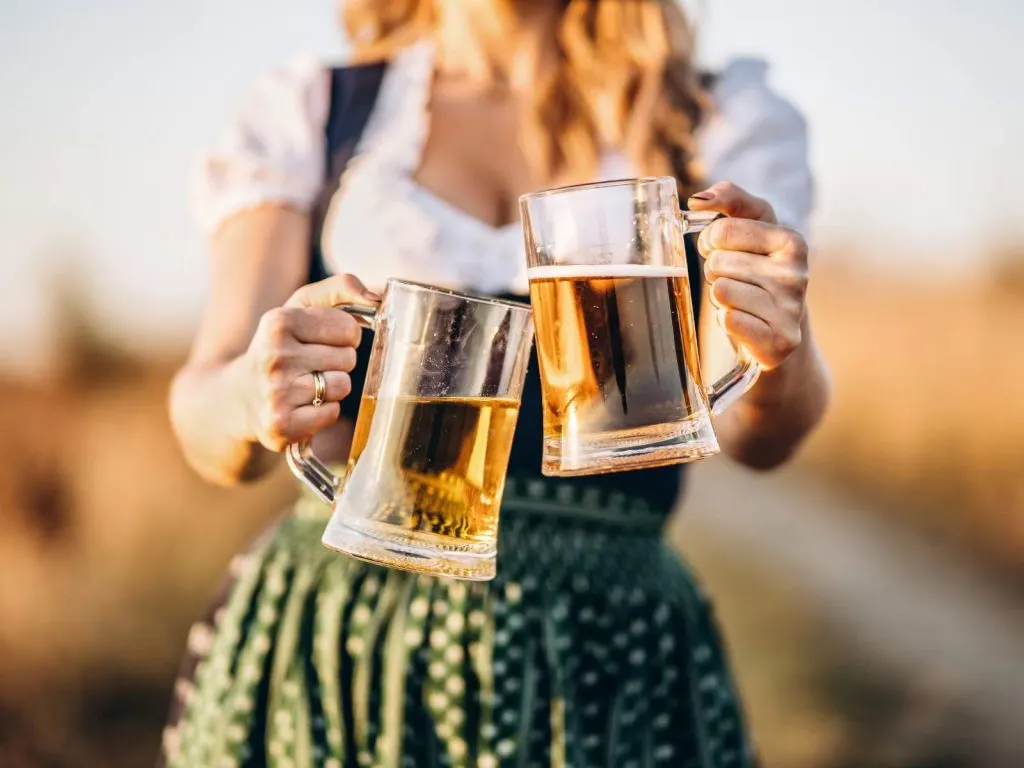 girl carrying two beer at Oktoberfest